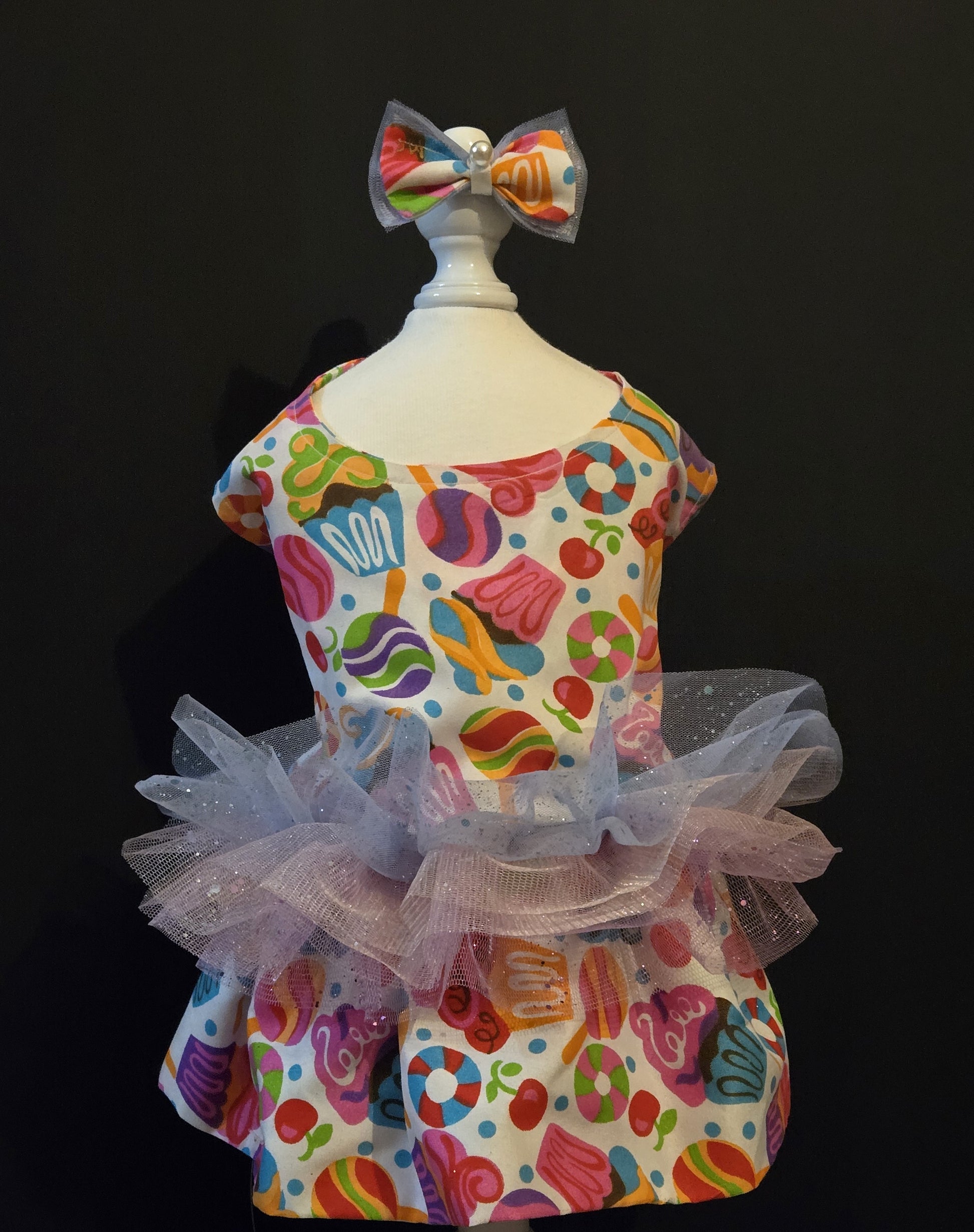 About Me: Birthday Confection
All items are Limited Quantity.
Birthday Confection All items are Limited Quantity. Cupcake, Lollipop, Candy and cherry printed multicolor dress. Multicolor and glitter Tulle waist details. Matching fabric and multicolor tulle hair bow with glitter details, pearl embellishment and white satin ribbon. Hair bow measures 3 inches wide and 2 inches tall. Fully lined dress.
Velcro added to neck and abdomen for comfort. Cotton Fabric.