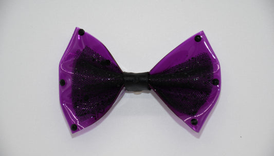 Purple Midnight Orchid Black Crystal Edition. All items are Limited Quantity. Made of Orchid colored clear vinyl fabric. Midnight tulle glitter fabric and hot Pink ribbon.
Carefully hand placed black rhinestone details on edges and center. Hair bow measures 3 inches wide and 2 inches tall.