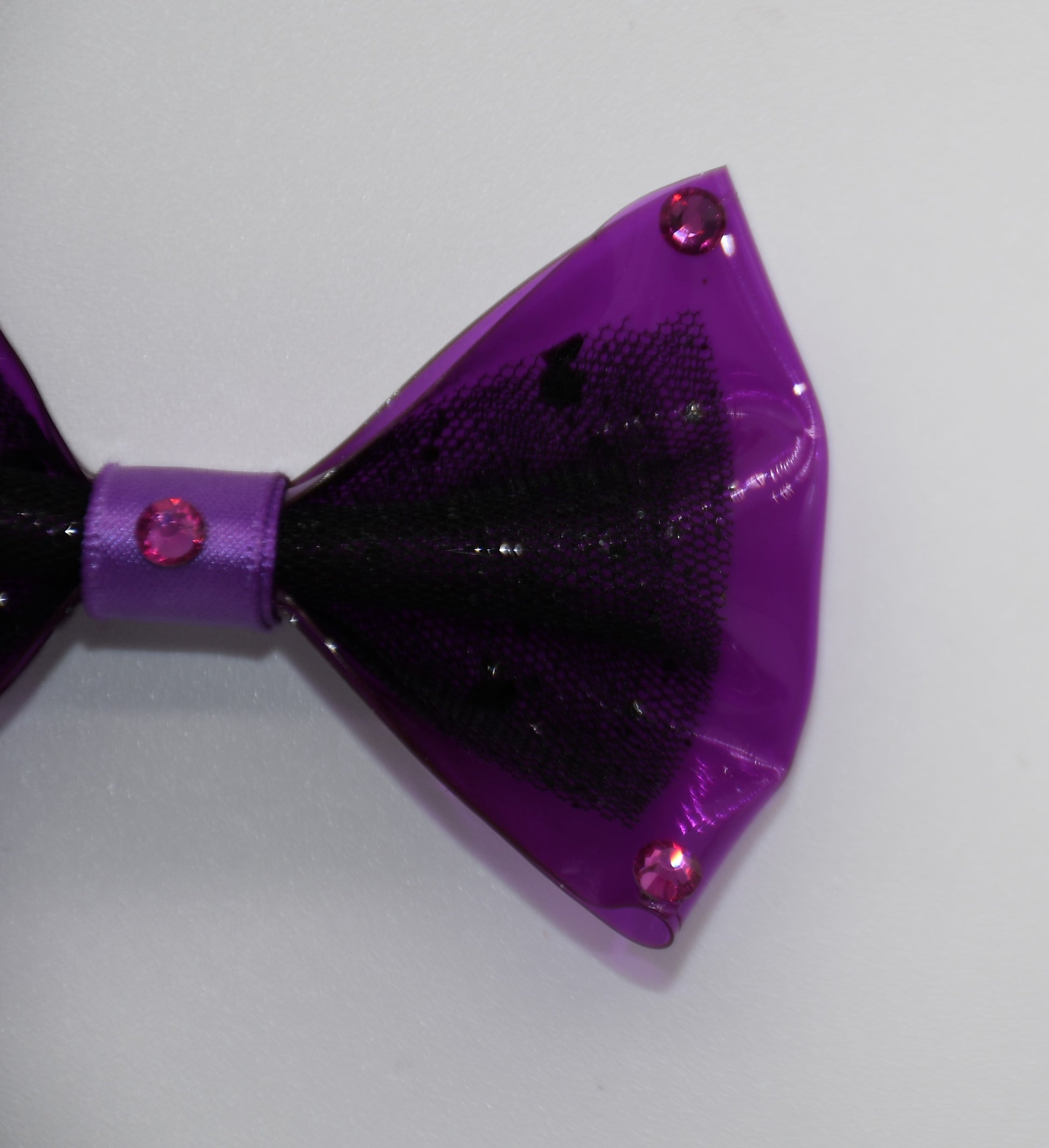 Midnight Orchid. All items are Limited Quantity. Made of Orchid colored clear vinyl fabric.
Midnight tulle glitter fabric and orchid colored satin ribbon.
Carefully hand placed rhinestone details at corners and center.
Hair bow measures 3 inches wide and 2 inches tall.