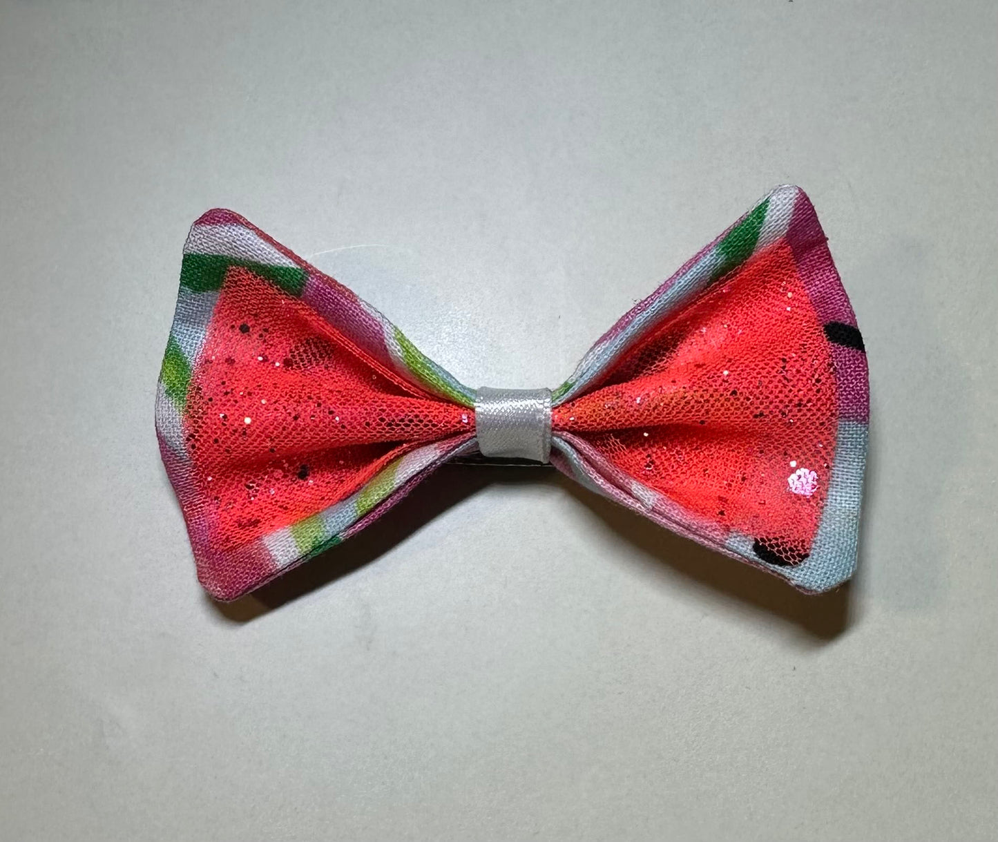 Made of a Watercolor Watermelon print fabric.
Glitter tulle fabric
White satin ribbon.
Hair bow measures 3 inches wide and 2 inches tall.
Head Designer Mister Fashion signs or initials all items on backside or somewhere in the lining.