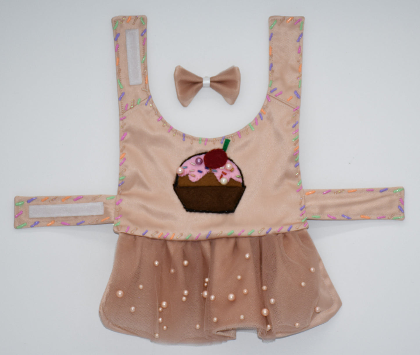 Chocolate Cupcake Fantasy (Chocolat) Dress. All items are Limited Quantity. Custom fabric made from a light brown sateen topped with a darker soft chocolate (chocolat) mesh. Chocolate (chocolat) colored tulle skirt with pearl embellishment. Hand painted sprinkles all over. Multiple layers of paint to give the 3D real sprinkle effect. Hand made felt chocolate cupcake patch with glass pearl and glass bead embellishments topped with a cherry. Matching fabric hair bow with white satin ribbon. 