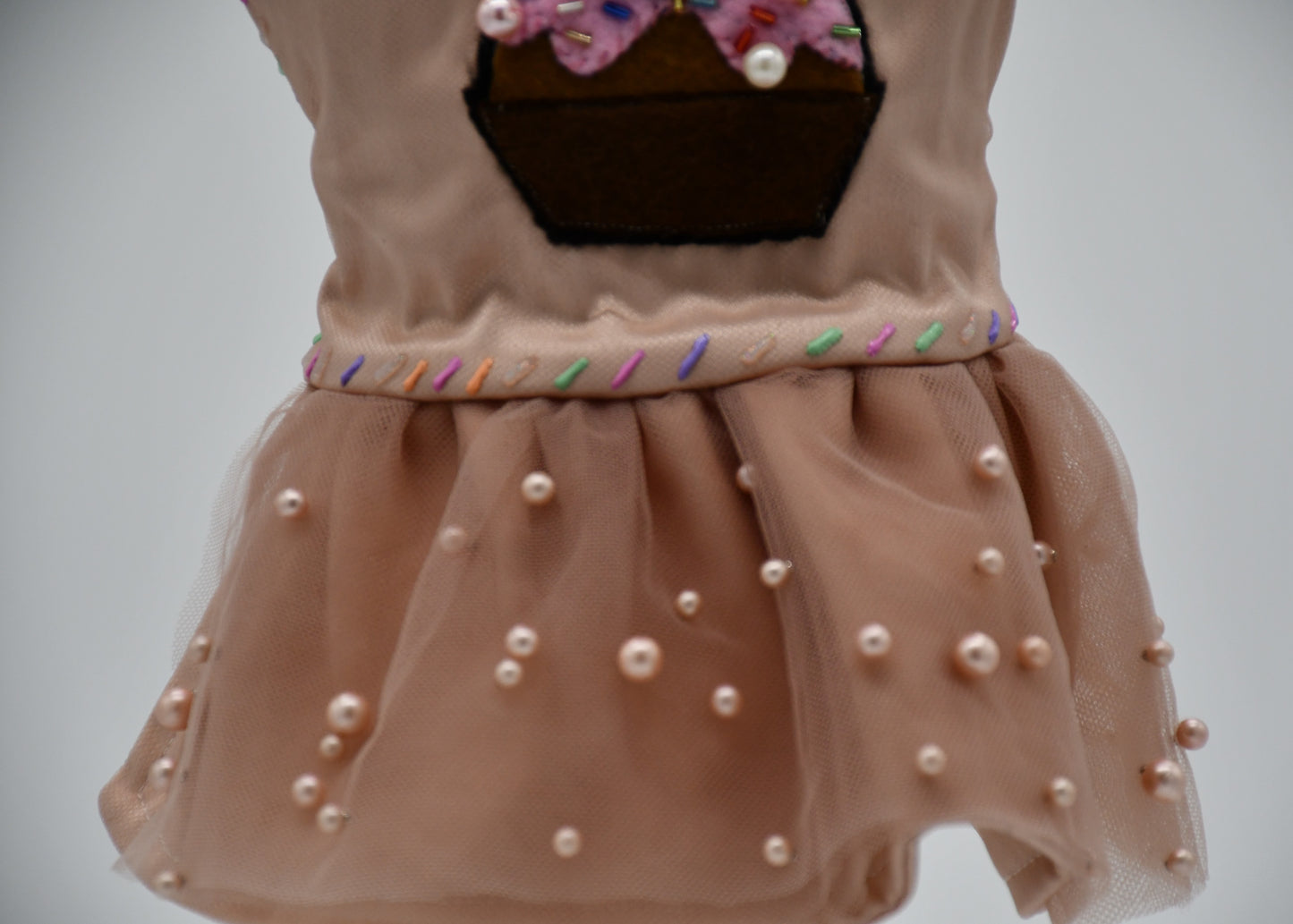 Chocolate Cupcake Fantasy (Chocolat) Dress. All items are Limited Quantity. Custom fabric made from a light brown sateen topped with a darker soft chocolate (chocolat) mesh. Chocolate (chocolat) colored tulle skirt with pearl embellishment. Hand painted sprinkles all over. Multiple layers of paint to give the 3D real sprinkle effect. Hand made felt chocolate cupcake patch with glass pearl and glass bead embellishments topped with a cherry. Matching fabric hair bow with white satin ribbon. 