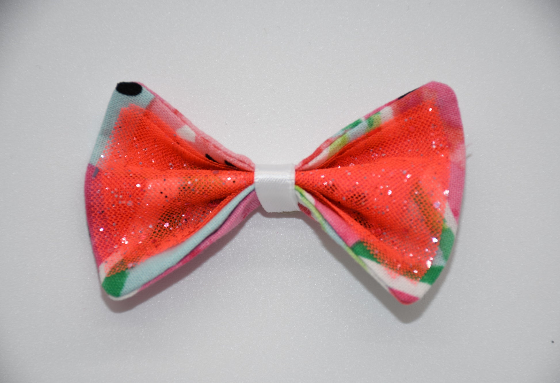 Made of a Watercolor Watermelon print fabric.
Glitter tulle fabric
White satin ribbon.
Hair bow measures 3 inches wide and 2 inches tall.
Head Designer Mister Fashion signs or initials all items on backside or somewhere in the lining.