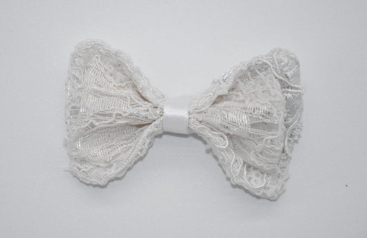 Enchanted Elegance White Lace Dog and Cat Hair Bow. All items are Limited Quantity. Made of white lace with small white sequin accents and minor 3d details. Double bow design. White ribbon. Hair bow measures 3 inches wide and 2 inches tall.