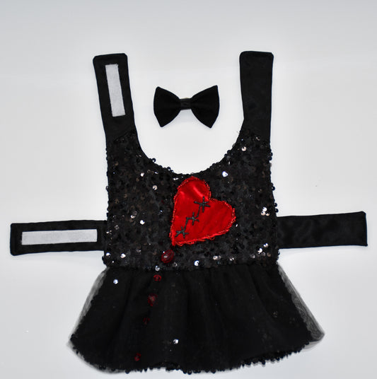 Bodice made of solid black non stretch sequin fabric.
Skirt made of solid black non stretch sequin fabric.
Soft solid black tulle skirt.
Ruby velvet and hand painted broken heart. Glass bead matching ruby embellishment resembling maggots around the heart but still playful and cute. Glass ruby beads coming down the bodice and tulle skirt resembling the witches ruby tears. 
Black fabric and midnight glitter tulle hair bow with a single black glass bead embellishment and black satin ribbon. Hair bow measures 3