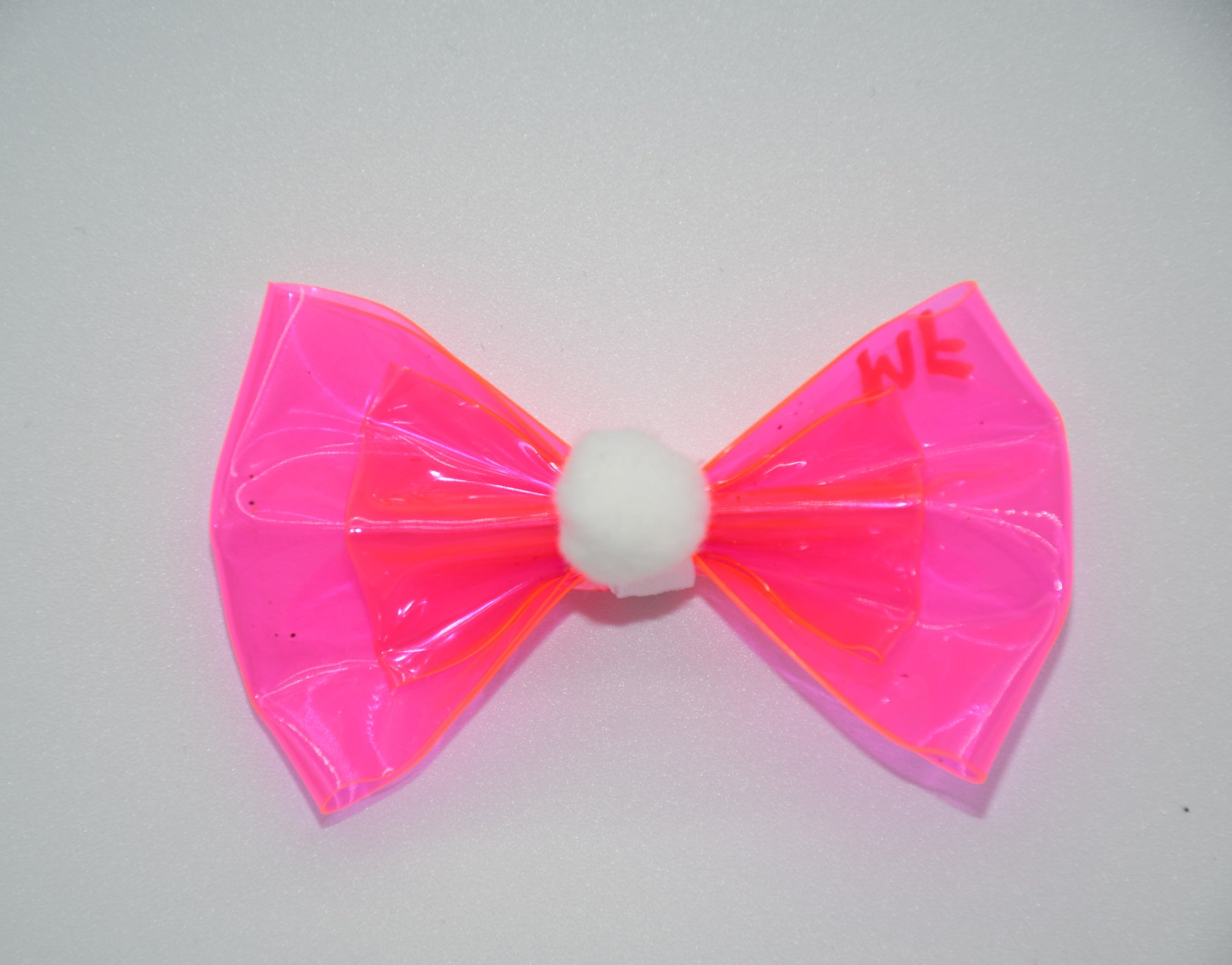 Fluffy Paws Dog and Cat Hair Bow.
All items are Limited Quantity.
Made of pink vinyl fabric and features a white pom pom. Double bow design and white ribbon. Hair bow measures 3 inches wide and 2 inches tall.