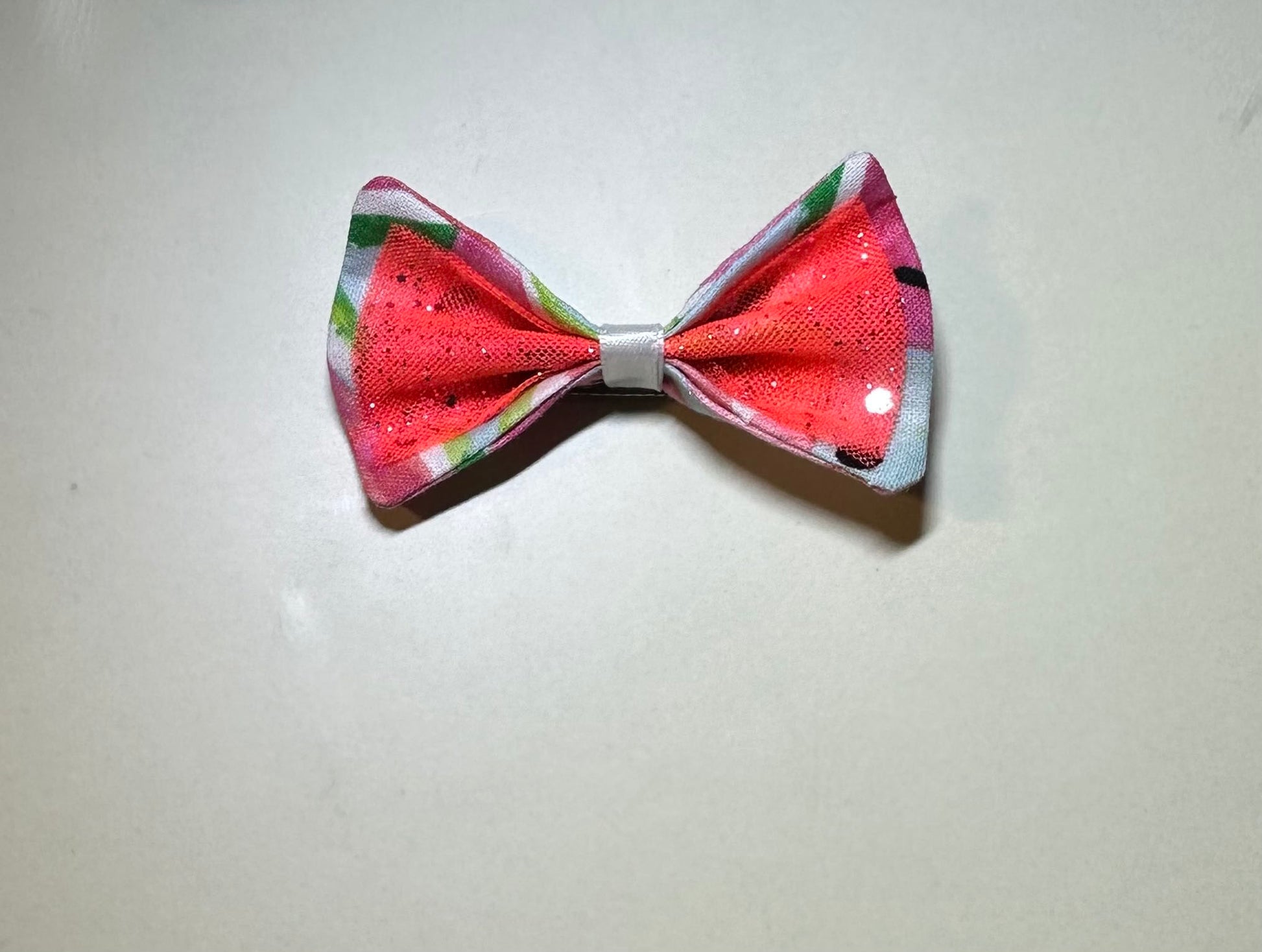 Made of a Watercolor Watermelon print fabric.
Glitter tulle fabric
White satin ribbon.
Hair bow measures 3 inches wide and 2 inches tall.
Head Designer Mister Fashion signs or initials all items on backside or somewhere in the lining.