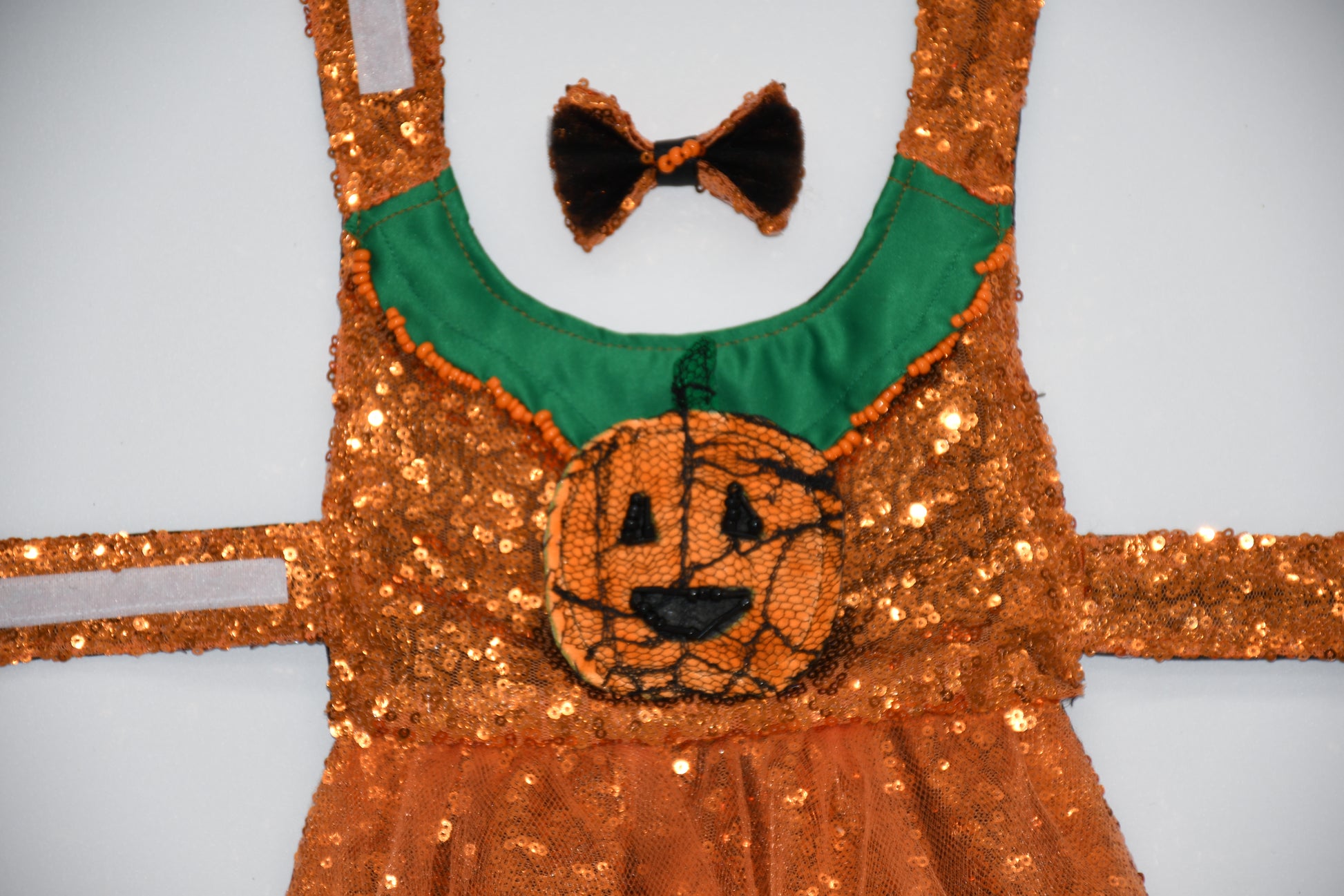 Jack-O-Lantern Extravaganza
All items are Limited Quantity.
Pumpkin colored sequin mesh fabric. Matching tulle fabric skirt.
Matching Pumpkin colored sequin fabric skirt with a pumpkin silhouette. Matching sequin fabric, black tulle, hair bow with glass bead embellishment and black satin ribbon. Glass bead embellishment resembles a maggot but still very playful and cute. Hair bow measures 3 inches wide and 2 inches tall.
Green collar with glass bead embellishment that resembles maggots (cute).Included is a 