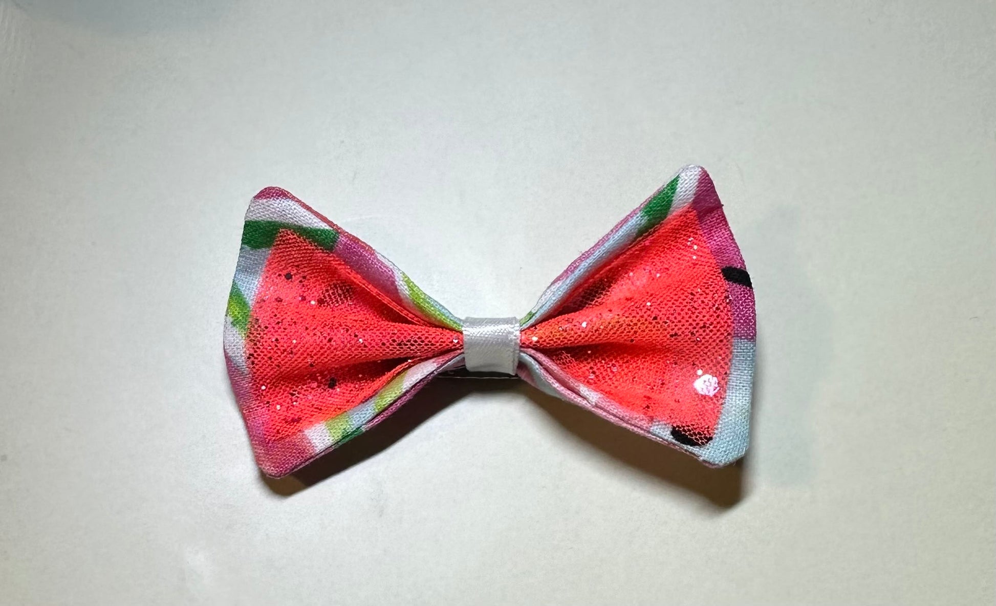 Made of a Watercolor Watermelon print fabric.
Glitter tulle fabric
White satin ribbon.
Hair bow measures 3 inches wide and 2 inches tall.
Head Designer Mister Fashion signs or initials all items on backside or somewhere in the lining.