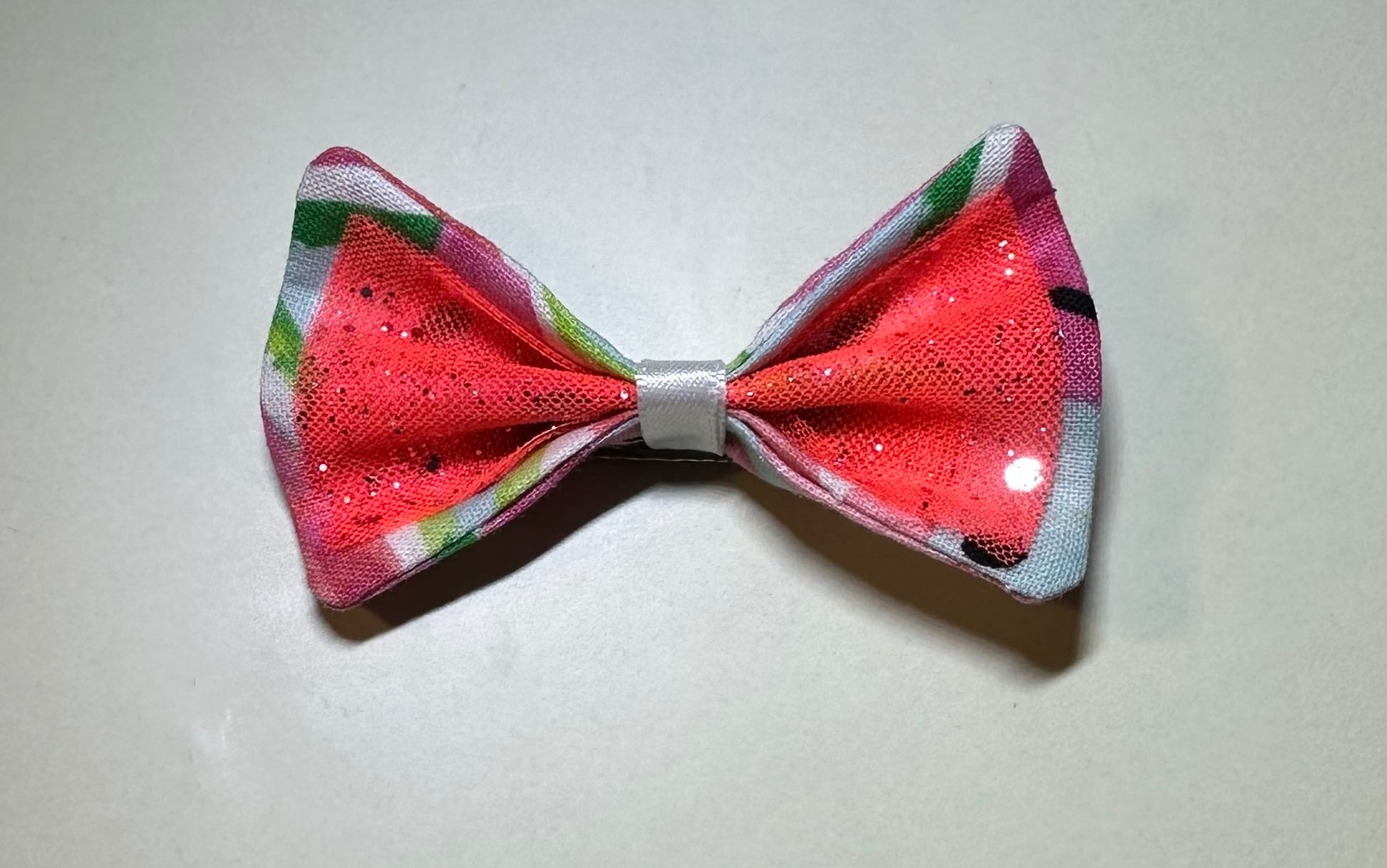 Made of a Watercolor Watermelon print fabric.
Glitter tulle fabric
White satin ribbon.
Hair bow measures 3 inches wide and 2 inches tall.
Head Designer Mister Fashion signs or initials all items on backside or somewhere in the lining.