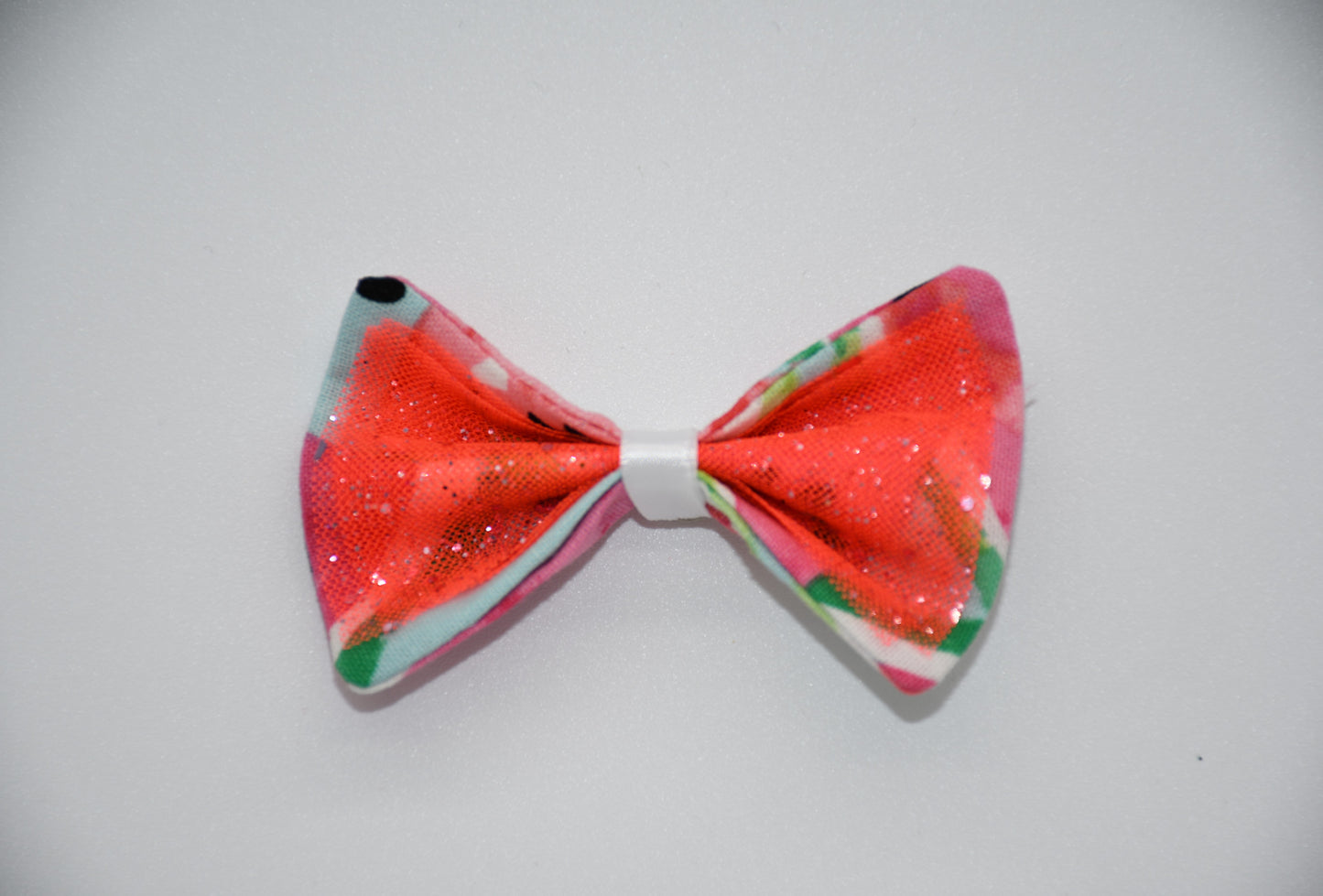 Made of a Watercolor Watermelon print fabric.
Glitter tulle fabric
White satin ribbon.
Hair bow measures 3 inches wide and 2 inches tall.
Head Designer Mister Fashion signs or initials all items on backside or somewhere in the lining.