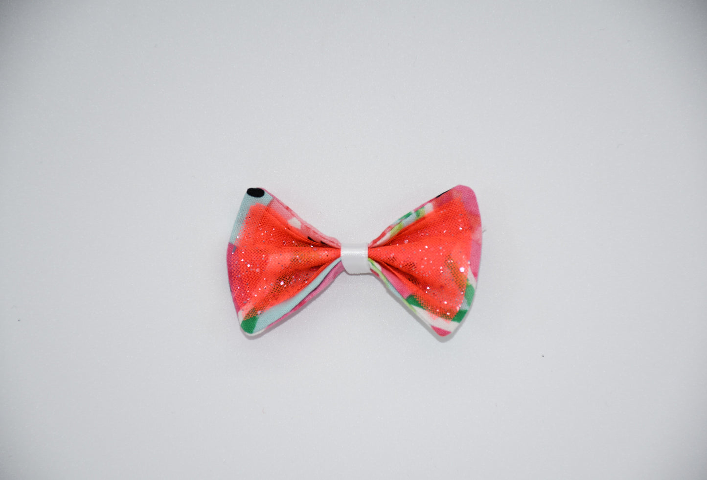 Made of a Watercolor Watermelon print fabric.
Glitter tulle fabric
White satin ribbon.
Hair bow measures 3 inches wide and 2 inches tall.
Head Designer Mister Fashion signs or initials all items on backside or somewhere in the lining.